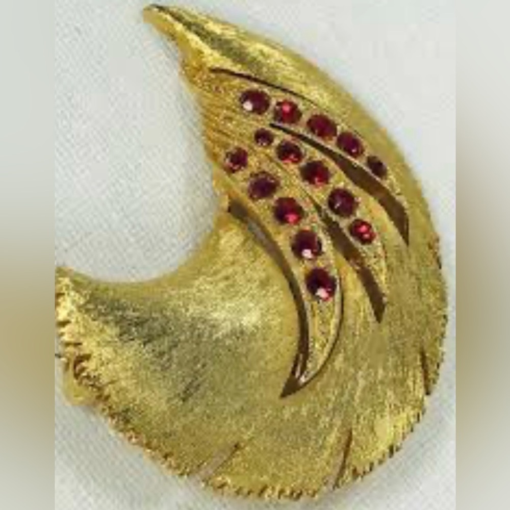 Jonette Jewelry Company, feather with inset red glass faux gemstones Brooch